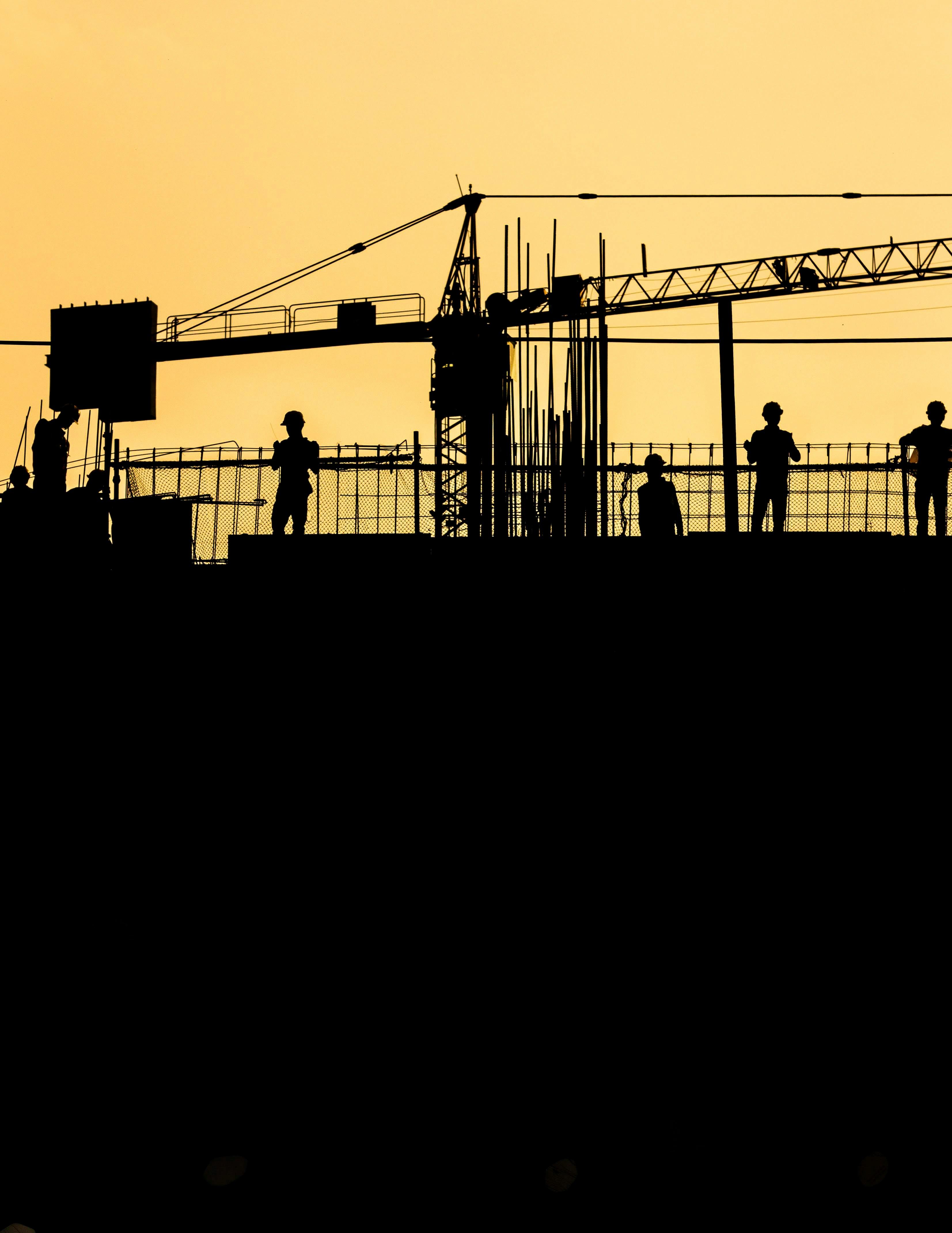 High-rise construction site with scaffolding and crane